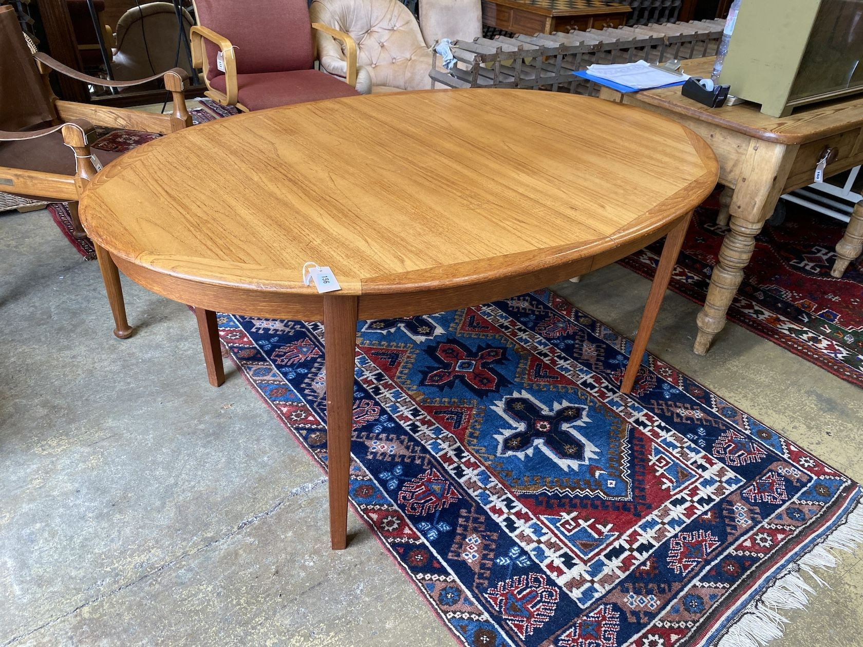 A mid century Drylund teak oval extending dining table, 220cm extended, depth 100cm, height 72cm